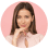 Woman smiling with pink background, thoughtful pose.